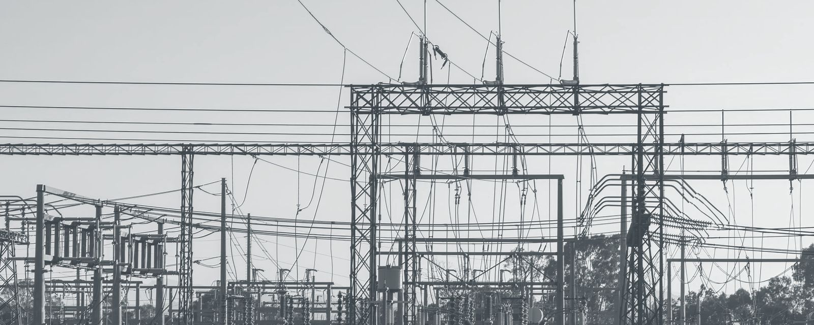 Power substation with steel structures and lines at dawn